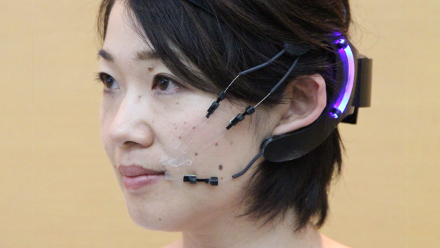 Woman with EEG nodes attached to her cheeks.