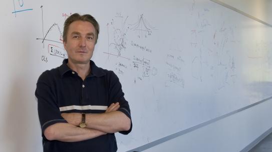 Guido Gerig in front of a white board