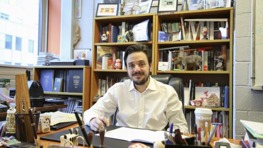 Maurizio Porfiri in his office with bookshelves in background