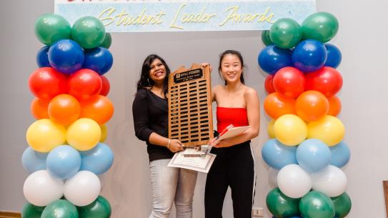 2 women students holding award