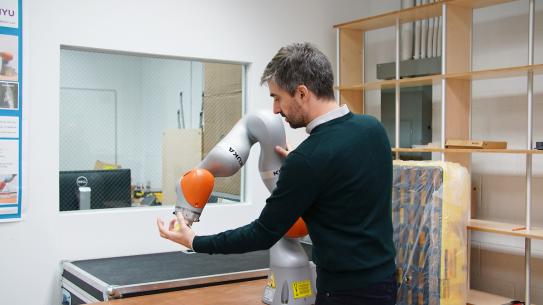 Professor Righetti working with robotic arm
