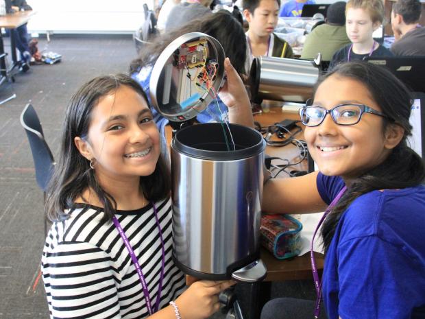 2 young girls working on a robotics project