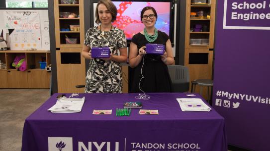 Cindy Lewis, Assistant Director of Special Events at NYU Tandon Office of Enrollment Management, and Elizabeth Ensweiler, NYU Tandon Director of Enrollment Management, demonstrate Tandon's two virtual reality mobile applications. 