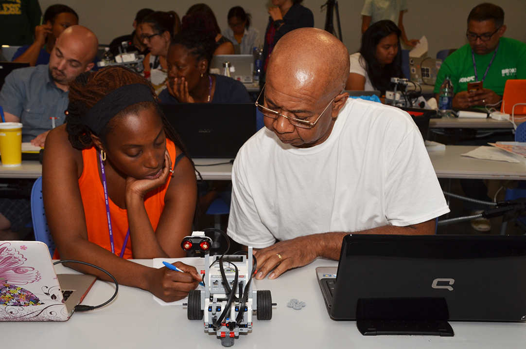 teachers building a robot together